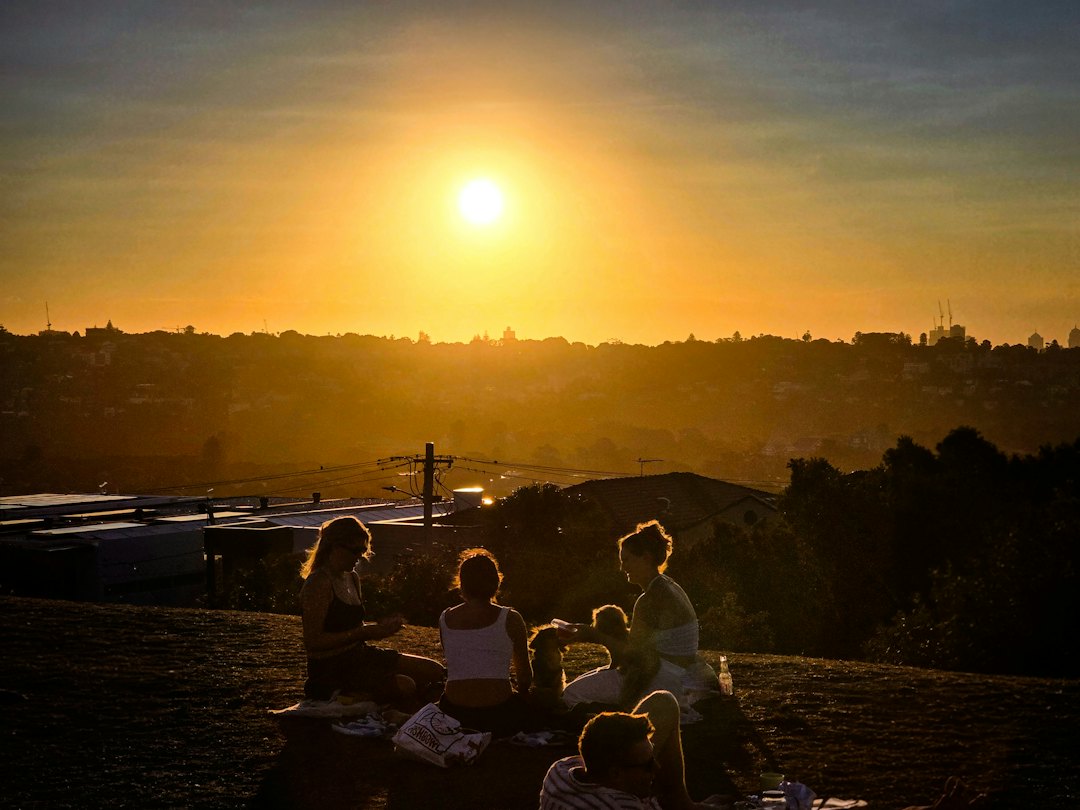 Community gathered outdoors at sunset